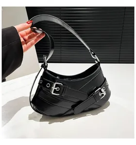 Detail of black motorcycle style underarm bag with silver buckles and adjustable strap