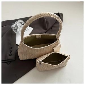 Detail of woven beige hobo bag set including mini pouch on professional background