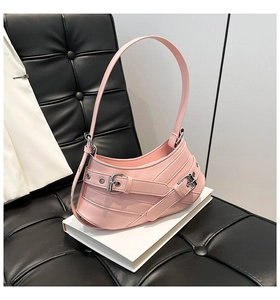 Detailed close-up of pink Y2K shoulder bag with silver metallic buckles and rivets