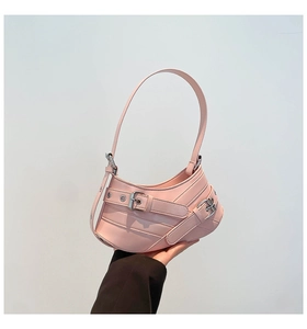 Detailed macro view of pink PU leather underarm bag with metal buckle strap and vintage texture