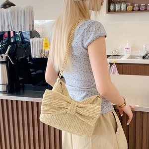 Straw weave handbag with large bow decoration and gold chain strap for summer vacation