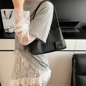 Elegant black woven leather hobo shoulder bag styled for commute with minimalist design