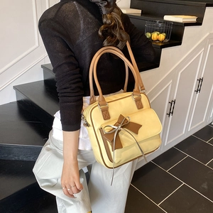Minimalist yellow and brown underarm shoulder bag with a bow detail and large capacity