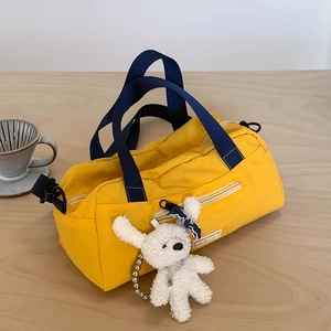 Lightweight yellow nylon travel tote with navy handles and a cute puppy pendant