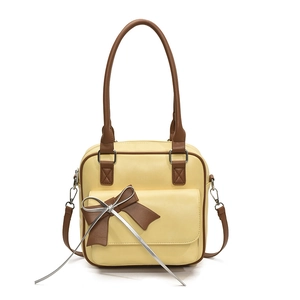 Minimalist yellow leather underarm bag with contrast brown trim and bow detail