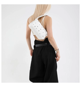 Detail of white studded motorcycle bag shown on shoulder for sizing and fit reference