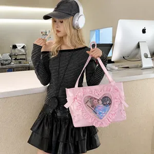 Detailed view of pink heart ita bag with ruffled transparent window and shoulder strap