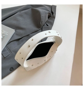 Close-up of white leather underarm bag with silver rivets and smooth zipper closure