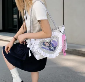Detailed view of white heart-shaped ita bag window featuring lace trim and ribbon details