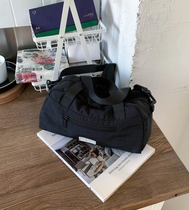 Detail of black nylon tote bag with CHIC CRAZE logo and detachable shoulder strap