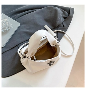 Macro detail of the interior lining, zipper pocket, and white pebble leather texture