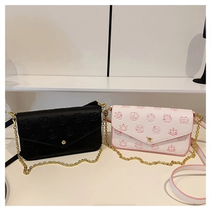 Detail of luxury flap crossbody bags in black pebble leather and white zodiac prints