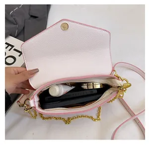 Macro view of interior storage capacity in white pebble leather chain crossbody bag