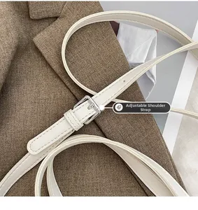 Detail of adjustable white PU leather shoulder strap with polished silver metal buckle