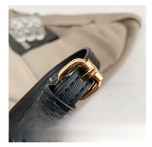 Macro view of adjustable black leather strap with premium gold metal buckle detail