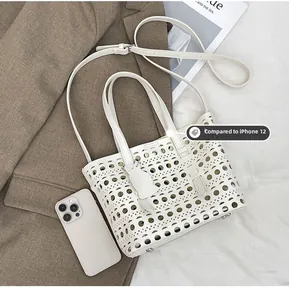 White cutout tote bag detail showing hollow design with iPhone 12 size reference