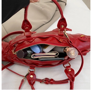 Close-up of red crocodile embossed handbag interior showing large storage capacity