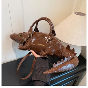 Detailed close-up of 3D crocodile-shaped handbag showing realistic scales and texture