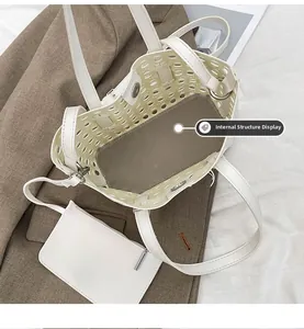 Detail view of the interior structure of white cutout tote bag with a small pouch