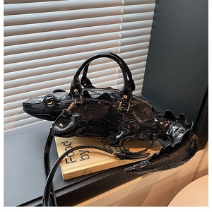 Close-up of black 3D crocodile handbag with glossy texture and zipper detail