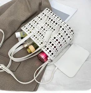 White laser-cut hollow tote bag with inner pouch showing large storage capacity
