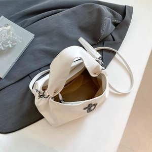 White PU leather tote bag with metal cross pendant and adjustable shoulder strap