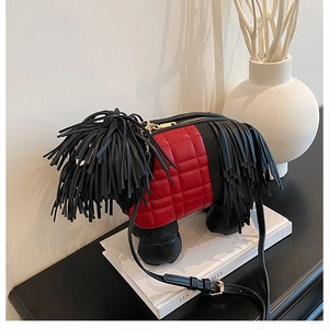 Close-up of red quilted crossbody dog bag with creative black leather tassels