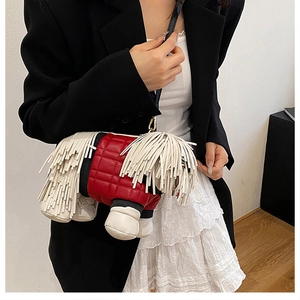 Creative dog-shaped crossbody bag with red quilting and white tassels on a model