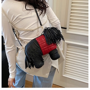 Model wearing a creative dog-shaped crossbody bag with red quilting and black tassels