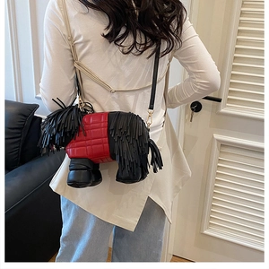 Detail of creative puppy-shaped crossbody bag with black tassels and red diamond stitching