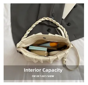 Detail showing the inner capacity of this pleated cloud bag with daily cosmetics and cards