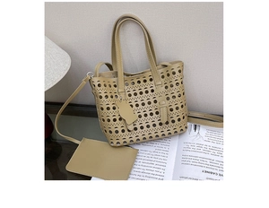 Detail of khaki hollowed-out tote bag with inner pouch and a cute cat shaped charm