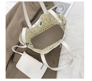 Detail view of white hollow-out tote bag interior with magnetic closure and inner pouch
