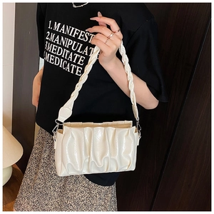 Détail du sac nuage plissé crème avec bandoulière tressée et boucle métallique