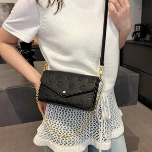 Retro embossed black crossbody bag with gold chain and vintage heraldic patterns