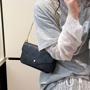 Elegant black crossbody chain bag with embossed texture and gold metal buckle detail