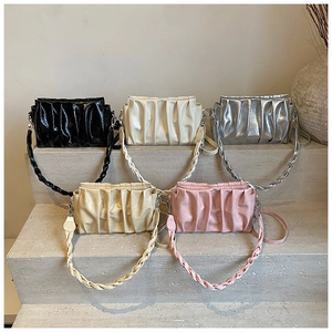 Close-up of ruched cloud bags in five colors showing textures and woven handles