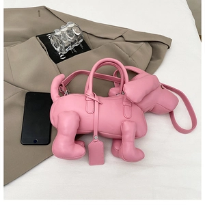 Detail of pink puppy-shaped leather handbag with rounded handle and dachshund silhouette