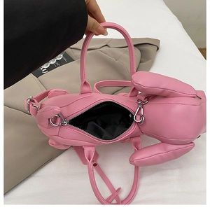 Detail view of pink bunny shaped shoulder bag interior with black lining and zipper
