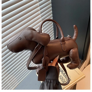 Detail showing deep brown puppy-shaped handbag with soft matte texture and leather tag