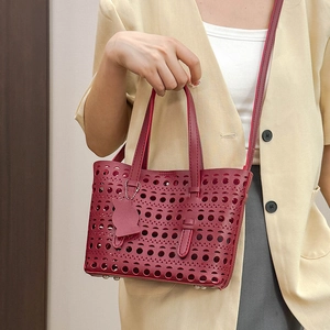 Burgundy cutout hollow tote bag with adjustable shoulder strap and cat charm