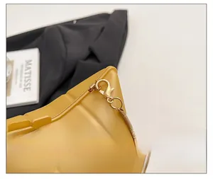 Detail of glossy yellow PVC star bag featuring gold snake chain and premium lobster clasp