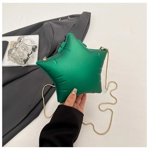 Détail du sac étoile en acrylique vert émeraude avec chaîne dorée et fini mat