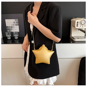 Detail shot of bright yellow star-shaped PVC crossbody bag with golden chain strap