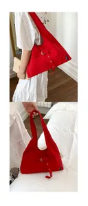 Détail du sac hobo en toile rouge avec boucle métallique et poche extérieure