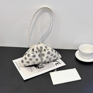 Detail of white glossy leather bucket bag with silver metal eyelets and chain drawstring