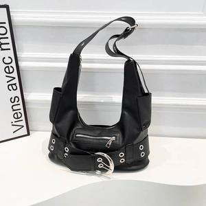 Detail of black Y2K motorcycle shoulder bag featuring multiple zippers and silver hardware
