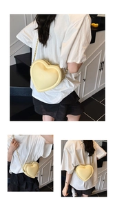 Multi-angle views of a heart-shaped crossbody bag in pale yellow leather with gold chain
