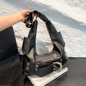 Detail of black leather biker shoulder bag featuring silver metal buckle and zipper