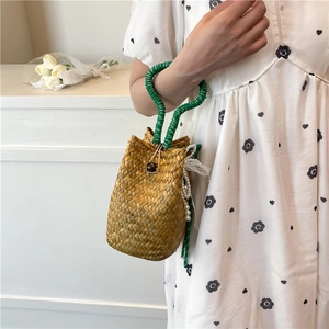 Handmade straw bucket bag with green handles and pearl lace charms for summer fashion